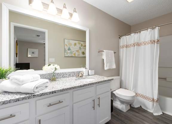 En-suite full-bath with granite counters, white cabinets and vanity lighting at Summerchase at Riverchase in Hoover, Alabama