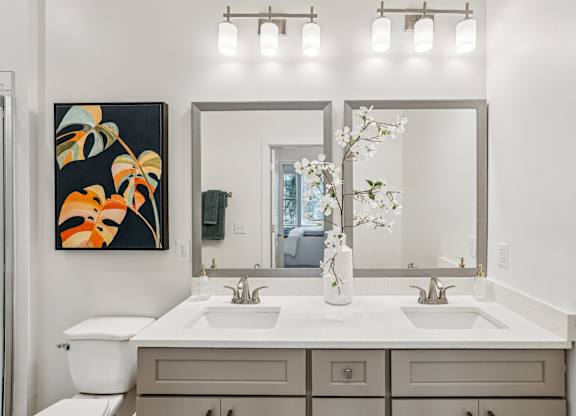 A bathroom with a white countertop and double sinks at Tapestry University Park apartments in Sarasota, FL