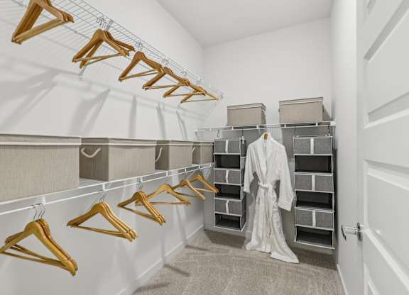 A row of wooden hangers are on a clothes rail.