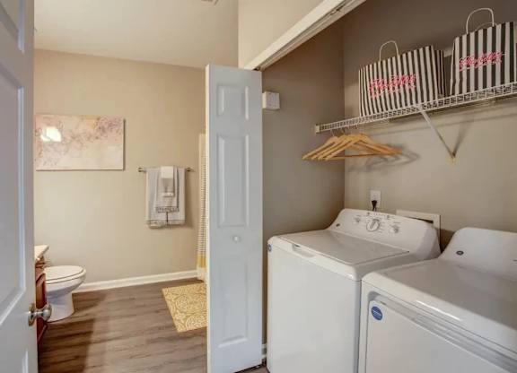 A bathroom with a toilet, sink, and a white door.
