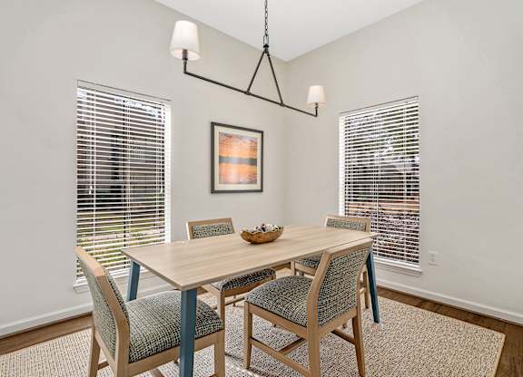 Flex room at Oakley at Hillcrest with a large table and two windows