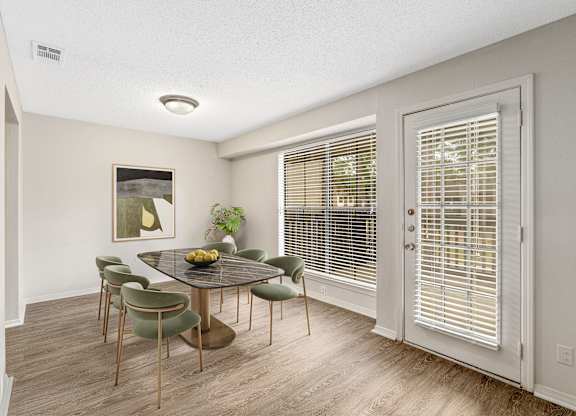 Large dining area in the model with staged six seater dining table at Oakley at Hillcrest