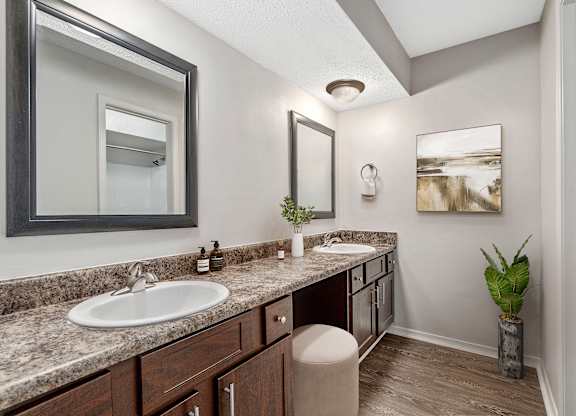 Primary bathroom with double vanities and large makeup vanity area at Oakley at Hillcrest in west mobile, al