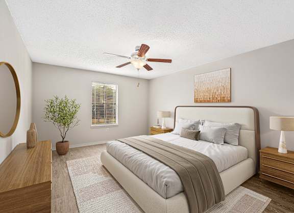 Oversized primary bedroom staged with a king size bed and two nightstands and dresser at Oakley at Hillcrest in west mobile, al
