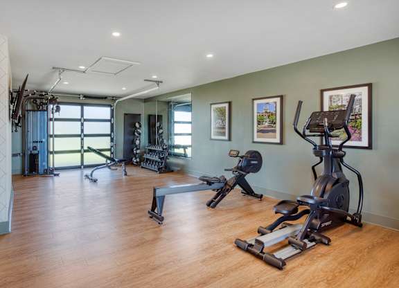 A spacious gym with a variety of exercise equipment.