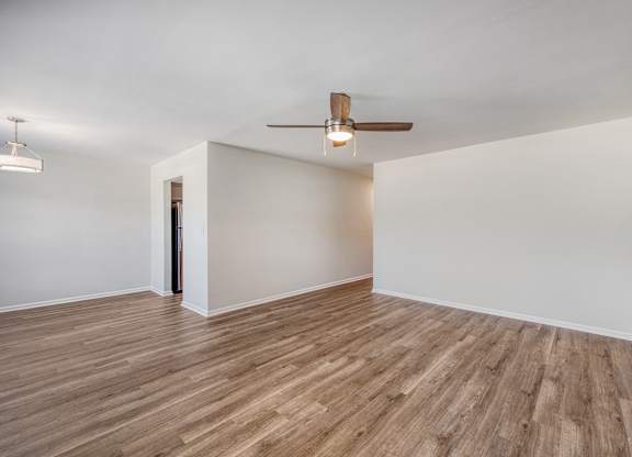 A room with a ceiling fan and light fixture.