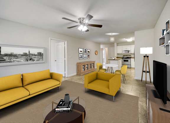 A living room with a yellow couch and a television.