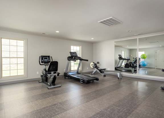 A spacious home gym with a variety of exercise equipment.