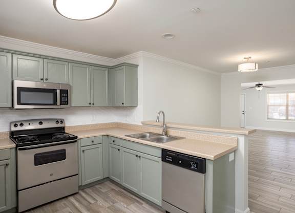 A kitchen with a stove, microwave, and dishwasher.