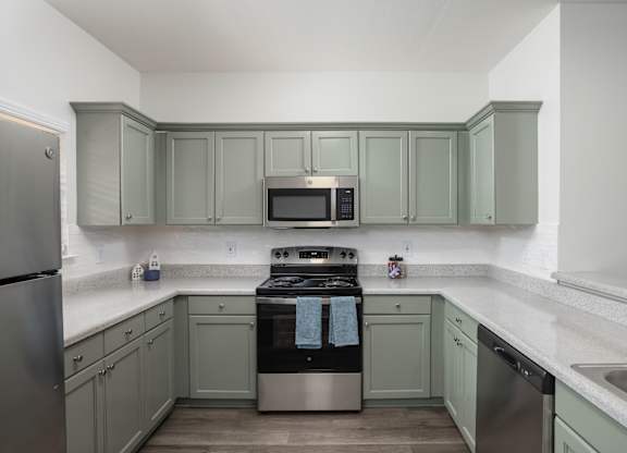 A kitchen with a stove, oven, and refrigerator.