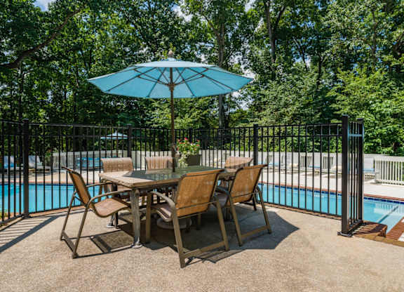 Poolside umbrella shaded table at Summerchase at Riverchase in Hoover, Alabama.