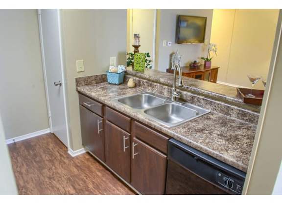 an open floor plan kitchen with designer plank flooring at at The Oakley at Hillcrest in Mobile, AL