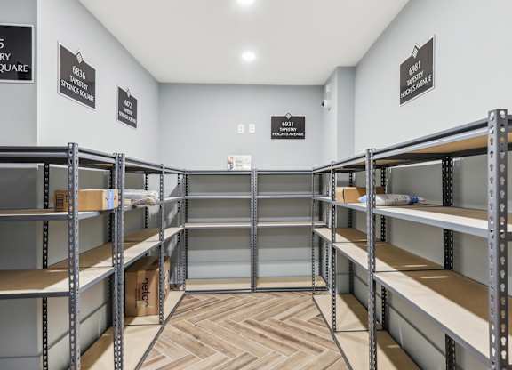 a room with bunk beds and shelving in it