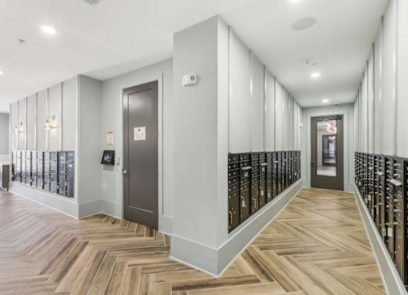 a long hallway with wooden floors and a door