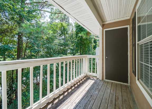 A wooden patio balcony surrounded by trees at Summerchase at Riverchase in Hoover, Alabama