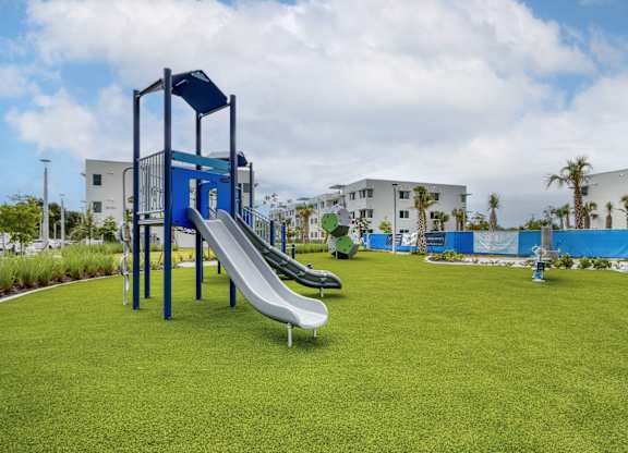 A playground with a blue and white slide.