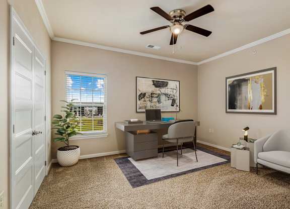 a home office with a ceiling fan