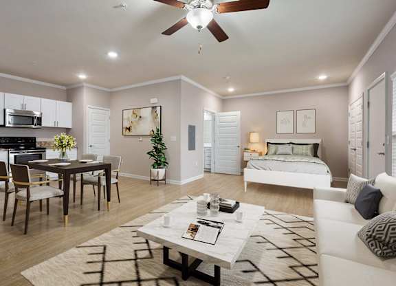 a living and dining room area with a bed in the background and a ceiling fan overhead