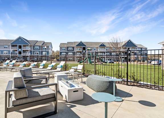 A sunny day at a resort with chairs and tables set up.