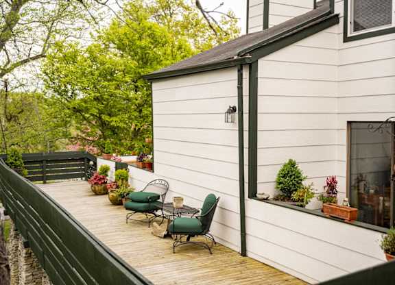 Apartment community with wooden deck and seating overlooking a lake at Saddlebrook at Tates Creek Apartments in Lexington, KY