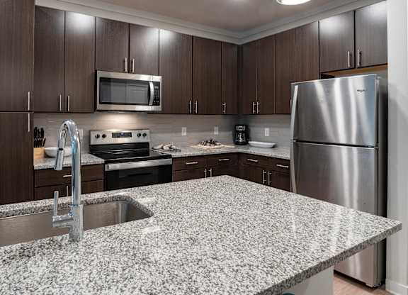 Spacious kitchen with granite countertops Coastal model Southern at Santa Rosa
