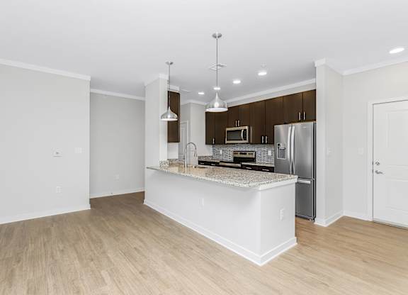 Large kitchen island with pendant lighting at Southern at Santa Rosa