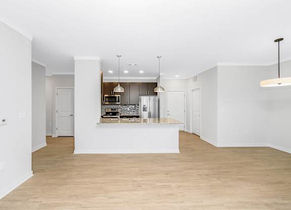 A  living room open to the kitchen with a large island Seabreeze floorplan