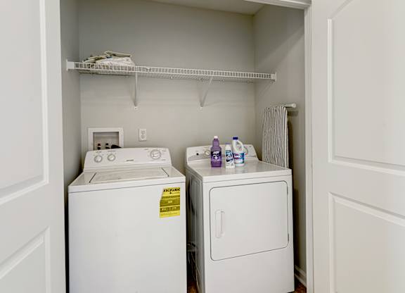 A small laundry room with a washer and dryer.