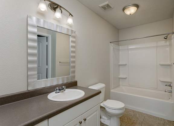 A white toilet sits next to a sink in a bathroom.