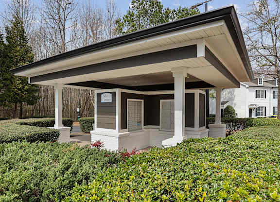 A small white house with a porch and a covered entrance.