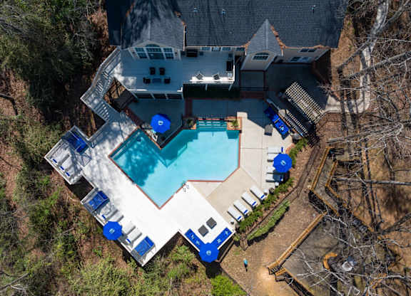 Ariel view of a large outdoor swimming pool surrounded by a deck and lounge chairs at Summerchase at Riverchase in Hoover, Alabama.