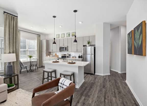 A modern kitchen with a dining table and chairs.