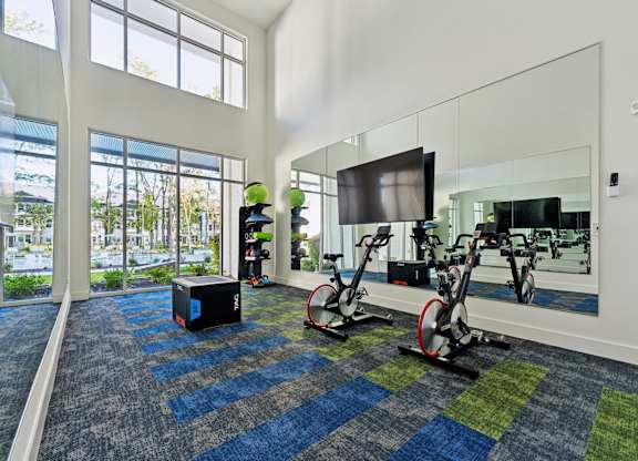 the preserve at ballantyne commons fitness room with weights and a tv