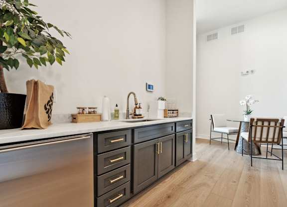 a kitchen with a counter top and a dining room with a table