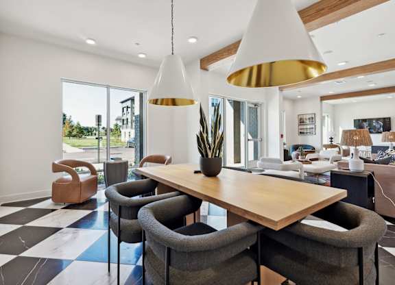a dining room with a wooden table and chairs