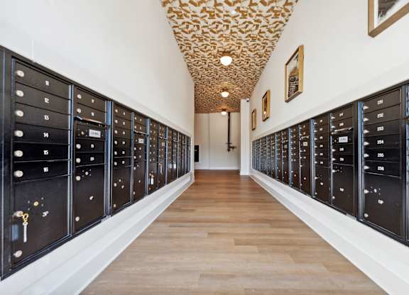 a long hallway with vaulted ceilings and a row of lockers