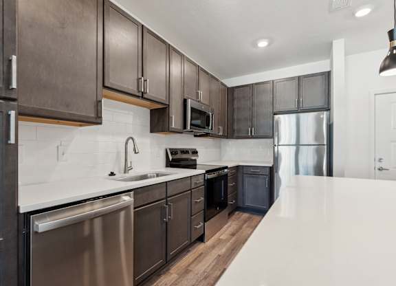a kitchen with stainless steel appliances and wooden cabinets