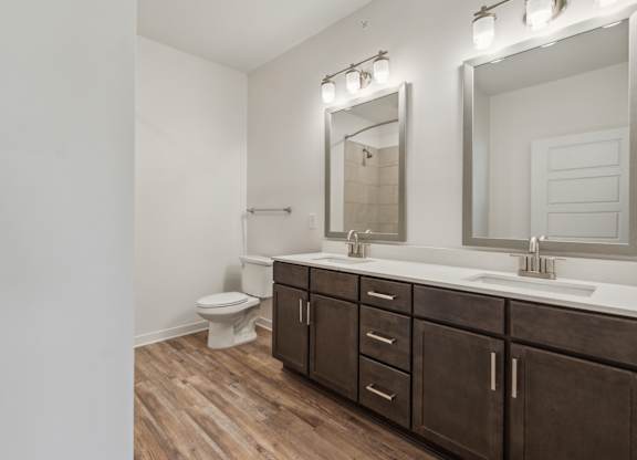 a bathroom with a toilet and a sink and a mirror