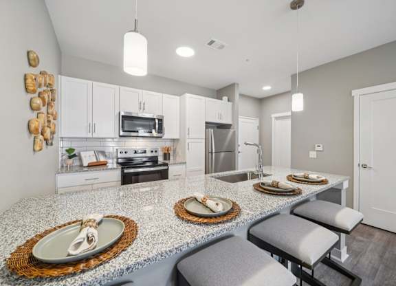 A kitchen with a granite countertop and a white oven.