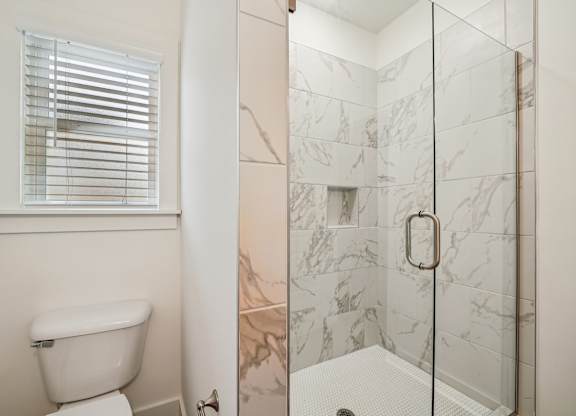 Bathroom with glass door shower at Turnberry Park Apartments in Gardendale, AL