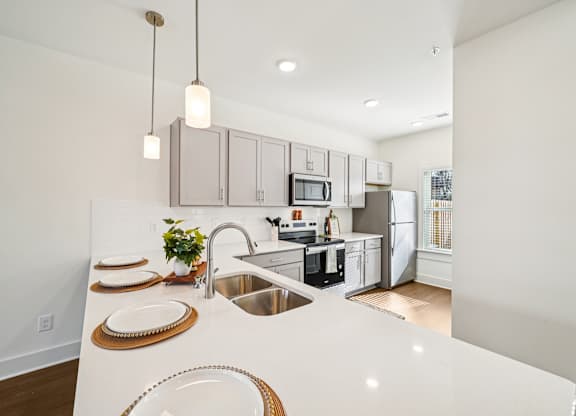 Large kitchen island with undermount sink at Turnberry Park apartments in Gardendale, AL