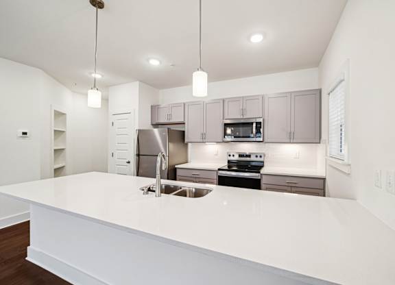 Modern kitchen with large island at Turnberry Park Apartments in Gardendale, AL