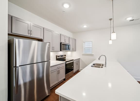 Modern kitchen with stainless appliances at Turnberry Park Apartments in Gardendale, AL