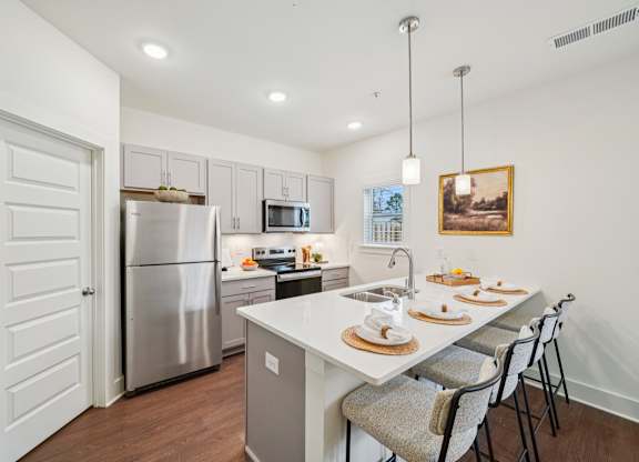 Modern kitchen with island seating at Turnberry Park Apartments in Gardendale, AL