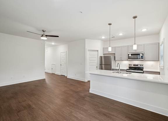 Modern kitchen with island seating at Turnberry Park Apartments in Gardendale, AL