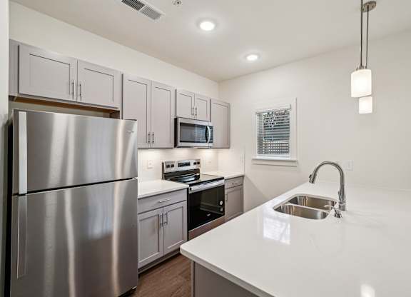 Modern kitchen with large island at Turnberry Park Apartments in Gardendale, AL