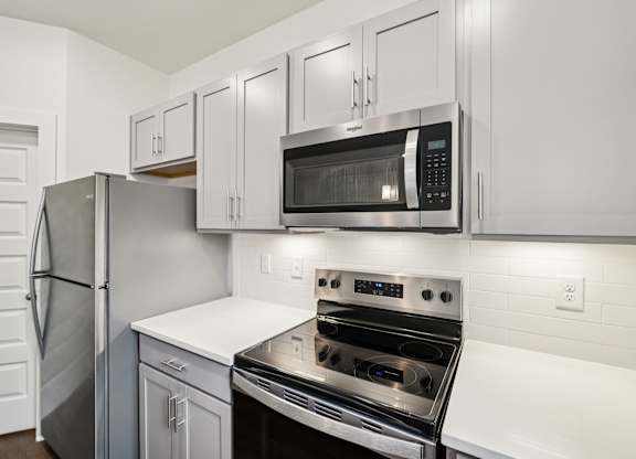 Modern kitchen with stainless appliances at Turnberry Park Apartments in Gardendale, AL