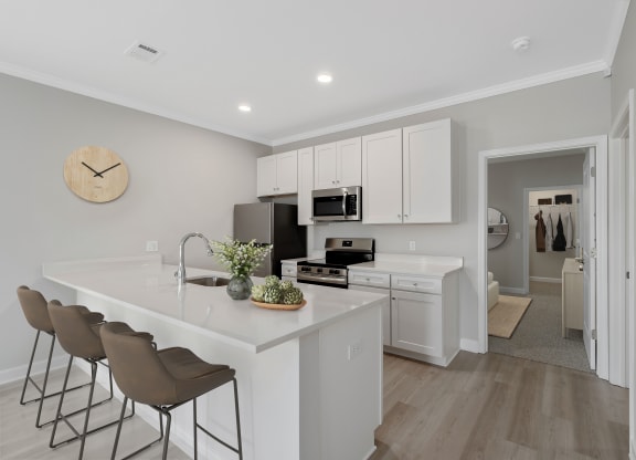 a kitchen with white cabinets and a white counter top at The Cottages at Foley Farms apartments in Foley, AL