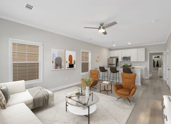 a living room with a couch and a table at The Cottages at Foley Farms apartments in Foley, AL