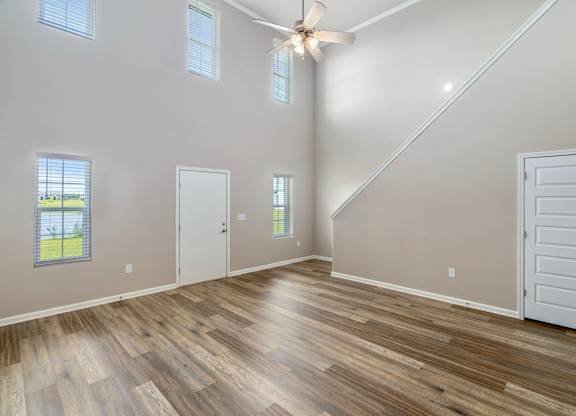 a living room with a vaulted ceiling and hardwood floors
